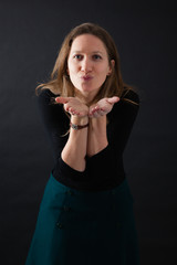 Fototapeta premium Beautiful woman doing different expressions in different sets of clothes: kiss