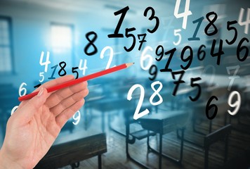 Fototapeta premium Composite image of hand holding red pencil 