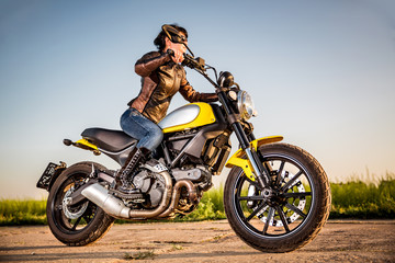 Naklejka na ściany i meble Biker girl on a motorcycle