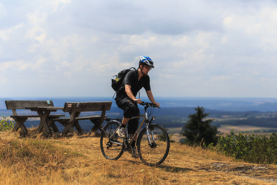 Biking in the Franconian Hills in Northern Bavaria. Young man on