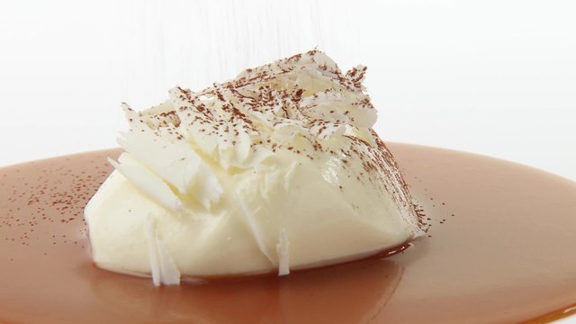 White chocolate mousse with chocolate curls, caramel sauce, cocoa