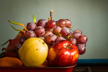 Apple in a red tray.
