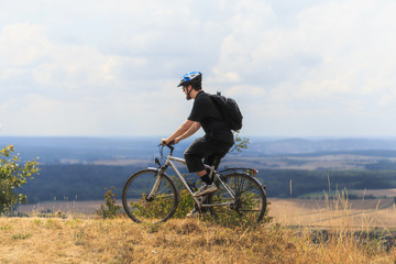 Fototapeta na wymiar Biking in the Franconian Hills in Northern Bavaria. Young man on