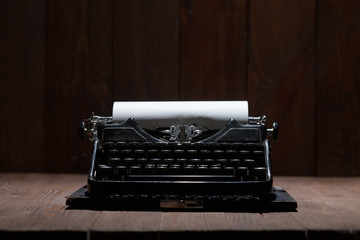 Typewriter over wooden background