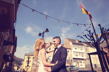 Bride and groom hugging in the city