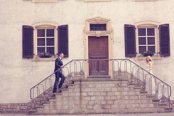 Bridal couple on stairs of their house