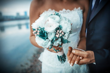 bride and groom holding wedding bouquet