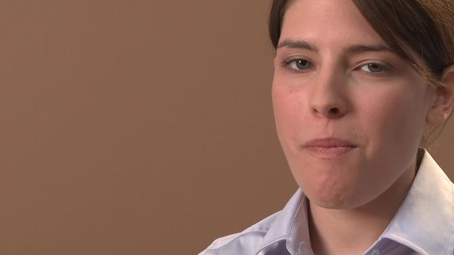 Young woman eating half a bagel with cream cheese