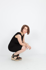 Obraz premium Beautiful woman doing different expressions in different sets of clothes: posing