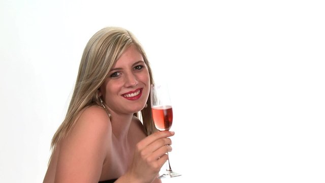Young woman drinking a glass of rosé sparkling wine