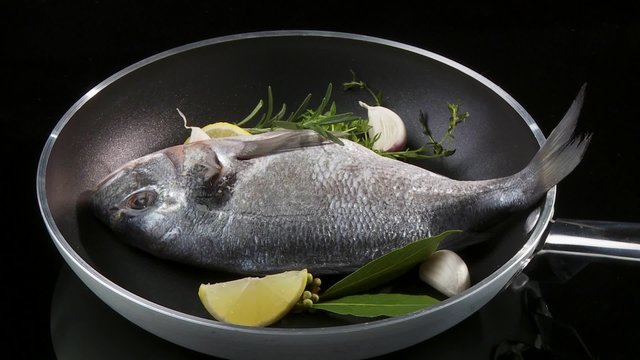 A sea bream in a frying pan