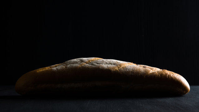 Loaf of bread on the dark background