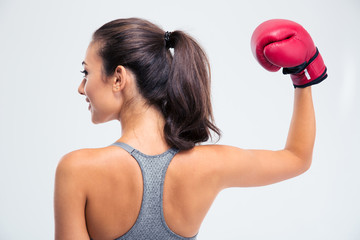 Woman standing with boxing gloves in victory pose
