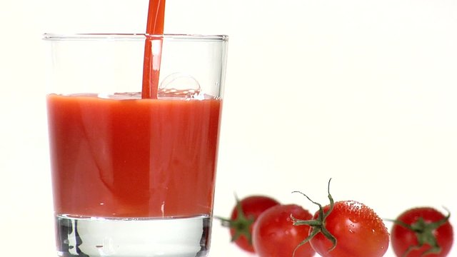Pouring tomato juice into a glass