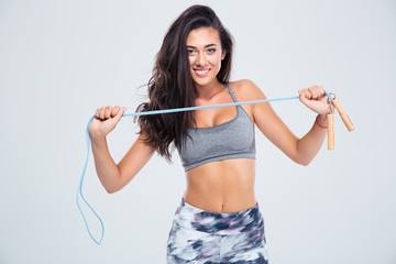 Charming woman holding skipping rope