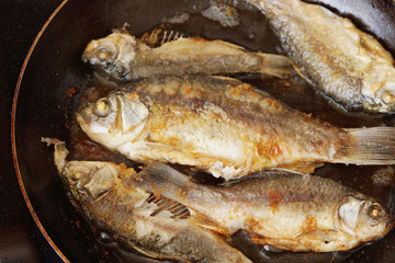 Fish is being fried on the frying pan