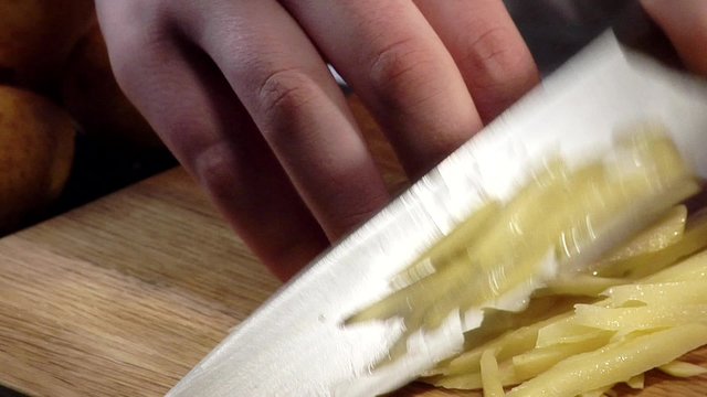 Cutting potato slices into sticks