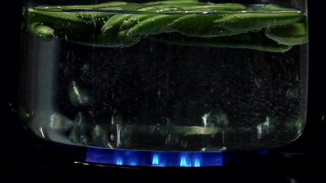Pea pods being cooked in hot water