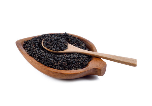 Heap of black Sesame (close-up shot) on wooden background