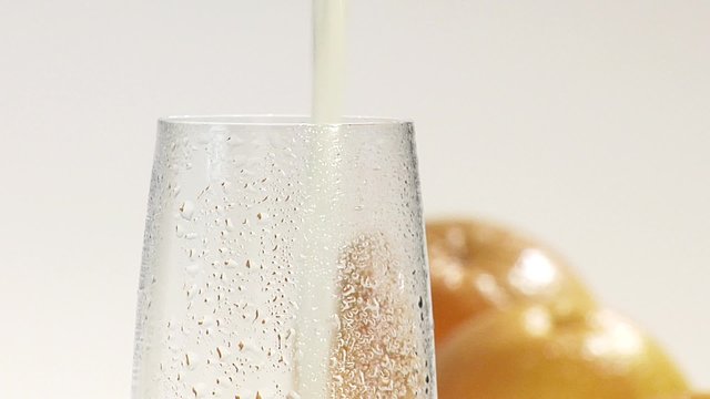 Pouring grapefruit juice into a chilled glass