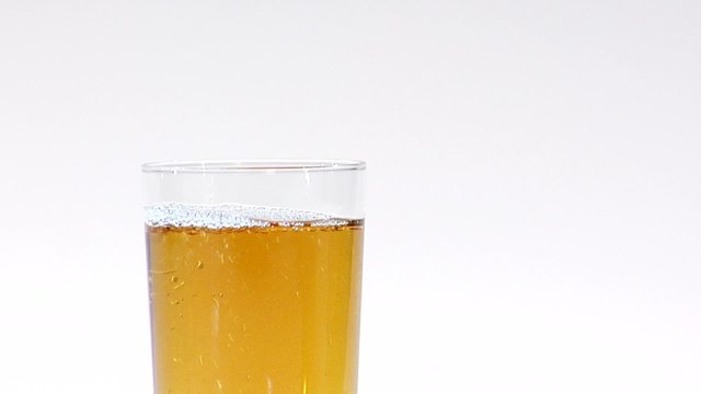 Pouring apple juice from a jug into a glass