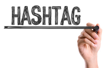 Hand with marker writing the word Hashtag