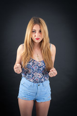 Fototapeta premium Beautiful girl doing different expressions in different sets of clothes: angry