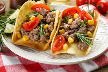 Mexican food Tacos in plate on napkin, closeup