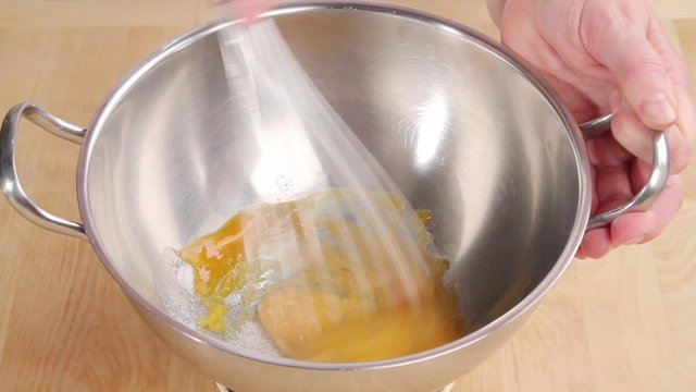 Whisking together egg yolks and sugar