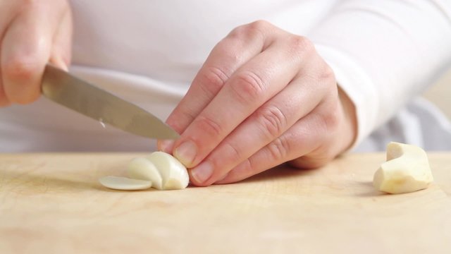Chopping garlic cloves finely