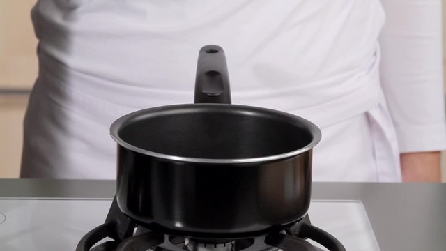 Pouring three tablespoons of oil into a saucepan