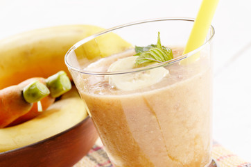 Carrot and banana shake on white table
