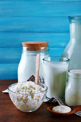 Dairy products on wooden table on blue  background