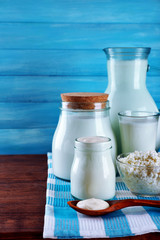 Dairy products on wooden table on blue  background