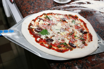 Preparing pizza on marble table, closeup