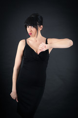 Fototapeta premium Beautiful woman doing different expressions in different sets of clothes: thumbs down