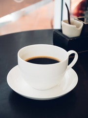 Black coffee with sugar in a cup, vintage (retro) style color effect