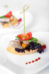 Tasty canapes on wooden table, close up