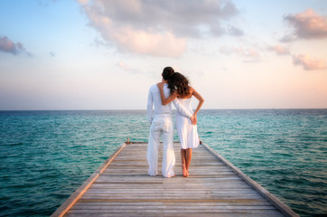 Sensual love couple on a jetty on Maldives