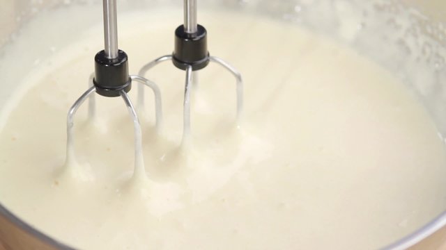 Butter cream being stirred with a mixer