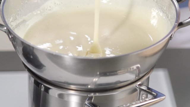 Butter cream being beaten over a bain marie