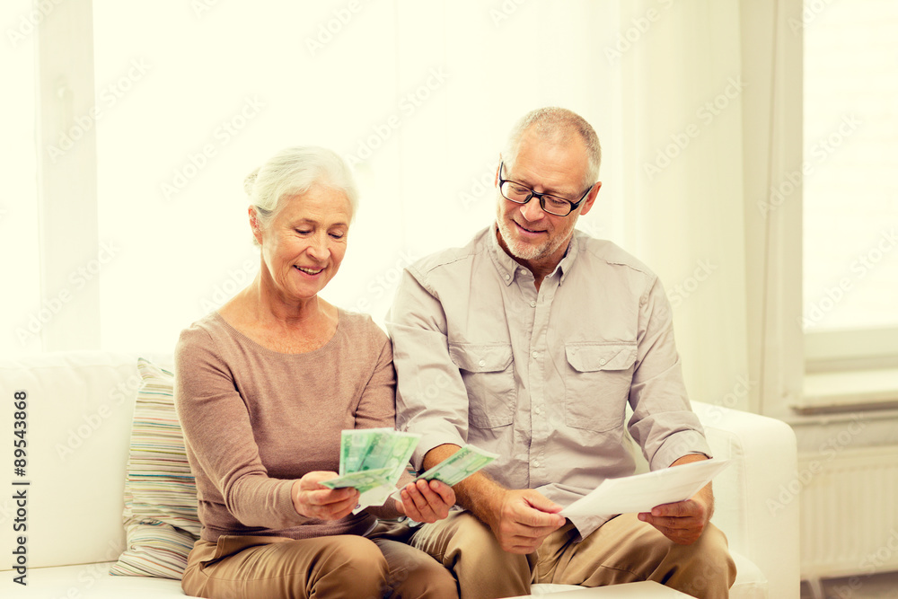 Poster senior couple with money and calculator at home