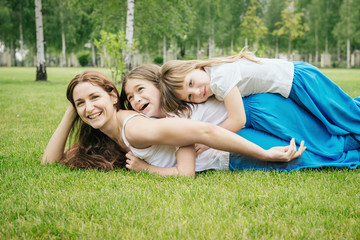 Mother with children having fun playing outdoors