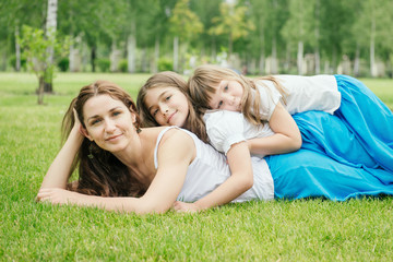 Fototapeta premium Mother with children spending free time playing outdoors