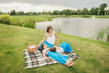 Mother with young daughters having picnic
