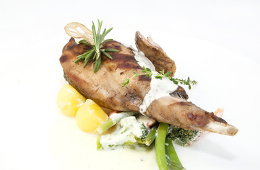 roasted rabbit meat and potatoes with vegetables