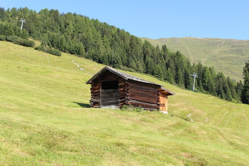 A wooden ski hut on Alp mountains with green meadow in Fiss, Tirol, Austria. 