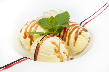 ice cream with caramel sauce and mint on a white background