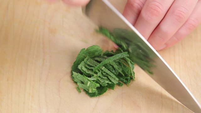 Mint leaves being finely sliced