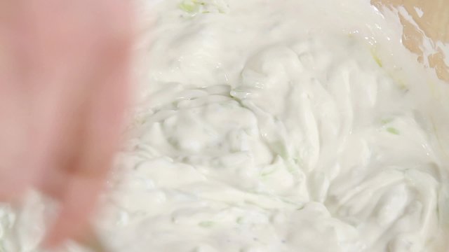 Ingredients for tzatziki being mixed together (detail)